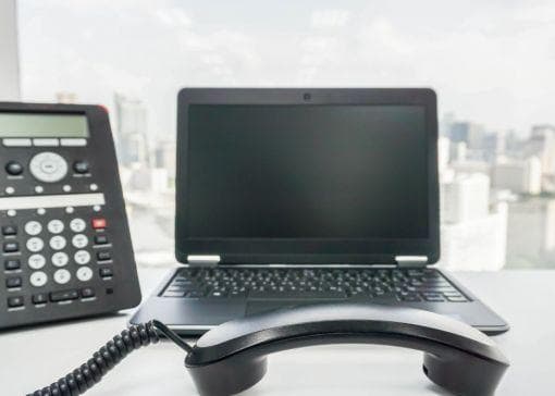 ip phone and laptop on desk
