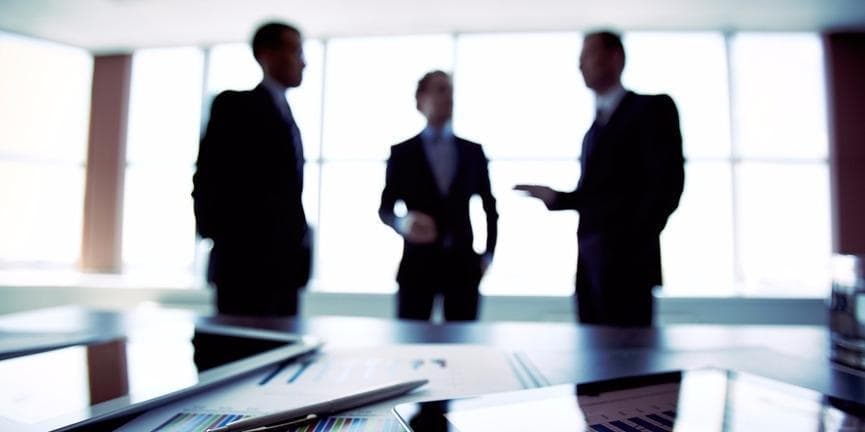 The telecommunications industry is in a wait-and-see mode as to whether or not the ink will eventually dry on the Mitel-Polycom merger agreement as a new competing bid surfaces. businessmen negotiating a deal