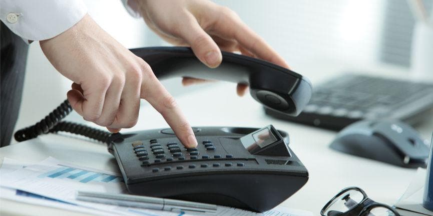 employee dialing on a business phone system