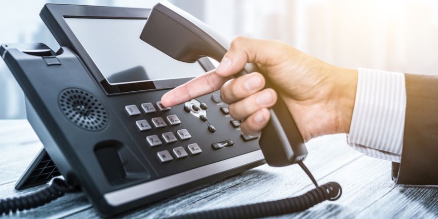 office worker dialing phone system