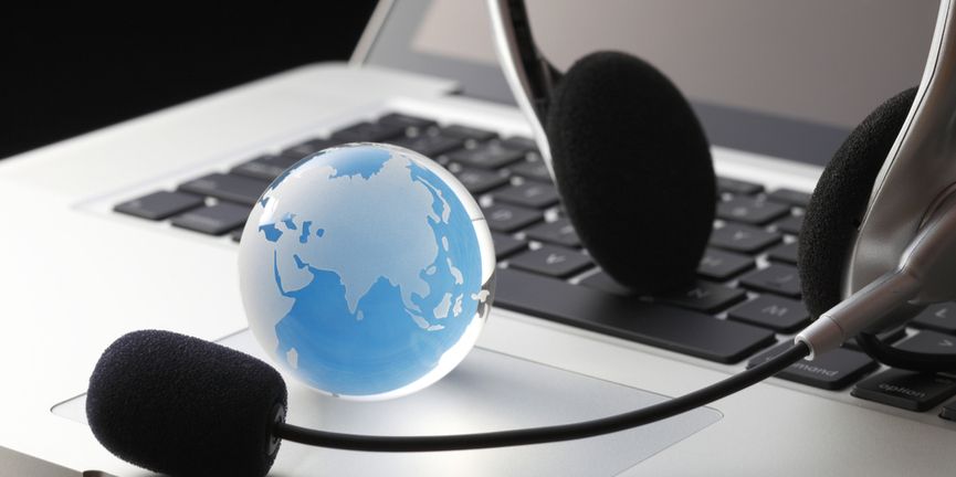 contact center headset on top of laptop computer