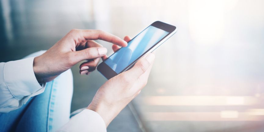 employee hand holding and using a smartphone