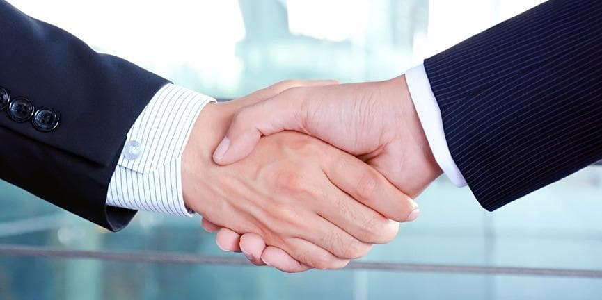 The Mitel-Polycom merger has a great potential to change the business communications space. businessmen shaking hands