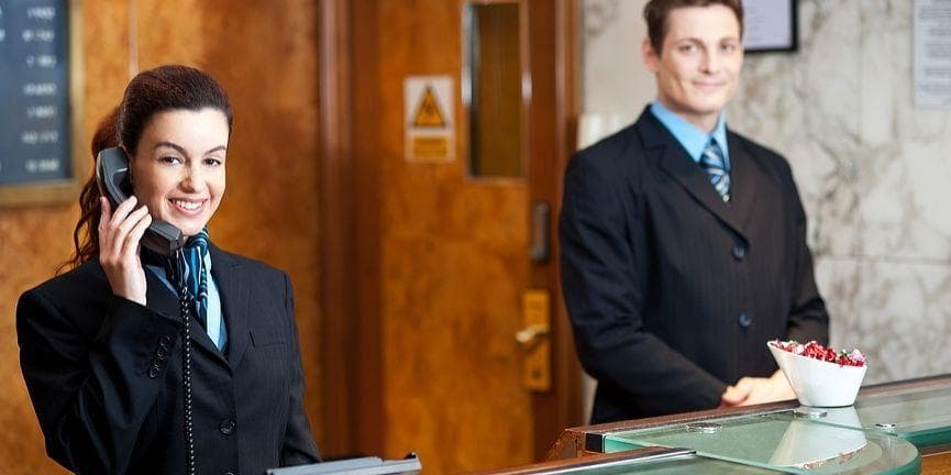 VoIP phone systems bring several advantages to hotels. hotel receptionist on the phone