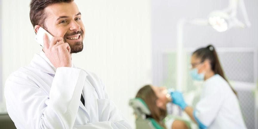 The challenges many dental offices face can easily be overcome by implementing a VoIP phone solution. dental practitioner on the phone