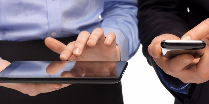employees holding smartphone and tablet