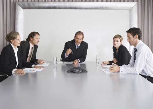 employees in a conference room on a conference call