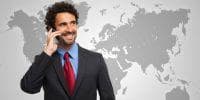 VoIP service providers offer some of the most affordable rates for international calling. employee using mobile phone for international call