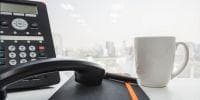 This Week in Telecom by VoipReview.org provides a simple, easy read of the latest news in the voice and telecom spaces over the past week. IP phone on office desk with notebook and coffee mug
