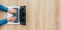 Twilio continues to build the future of communications with its newest offerings: Proxy and Functions. employee typing and coding on laptop computer