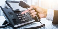 This week's news roundup includes stories from Arkadin, VOSS Solutions, Dialpad, and Audiocodes. office worker dialing phone system