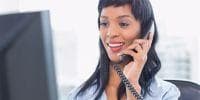 businesswoman answering office phone