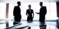 The telecommunications industry is in a wait-and-see mode as to whether or not the ink will eventually dry on the Mitel-Polycom merger agreement as a new competing bid surfaces. businessmen negotiating a deal