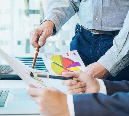 VoIP technology and tools like CRM integrations can help accountants stay organized. accountants working with graphs and documents