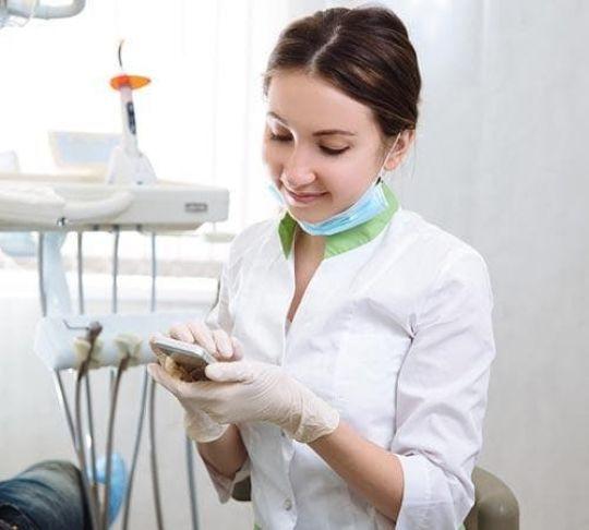 dental hygenist on mobile phone
