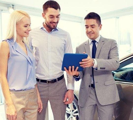 car salesman at car dealership