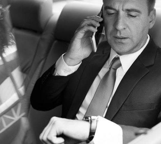 client in limo on mobile phone