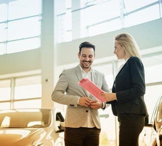 car salesperson discussing with customer