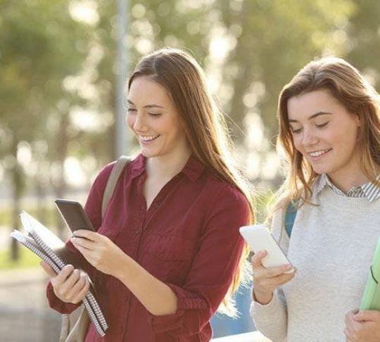 two university students on mobile phones