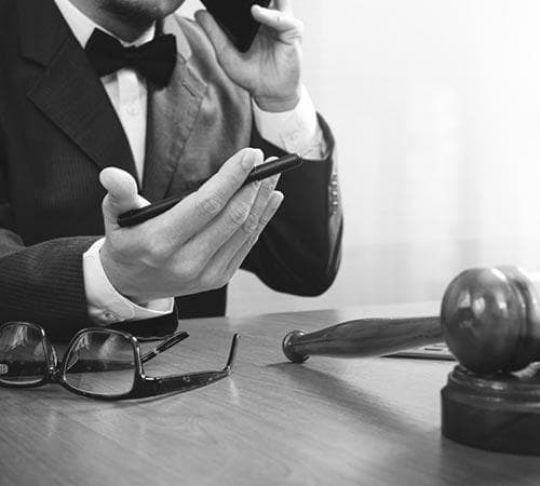 judge on the stand on a mobile phone