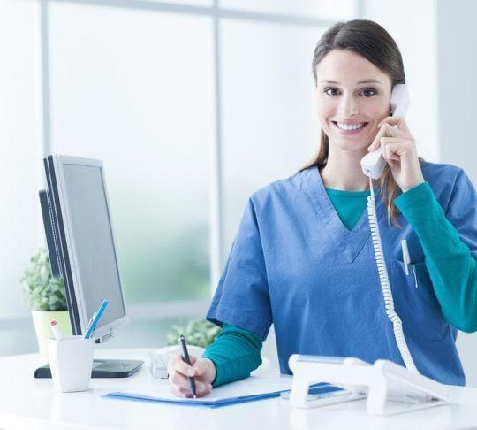 female nurse on phone at desk