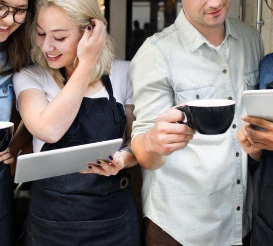 restaurant employees with phone and tablet