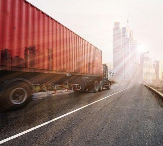 truck driving on a highway to the city
